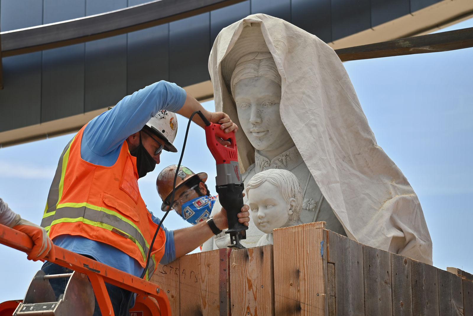 A statue of Mary and baby Jesus is unboxed and prepared for installation in Christ Cathedral’s new Catholic Vietnamese memorial being built on the campus. Photo courtesy Diocese of Orange. Note: Photo taken during construction.