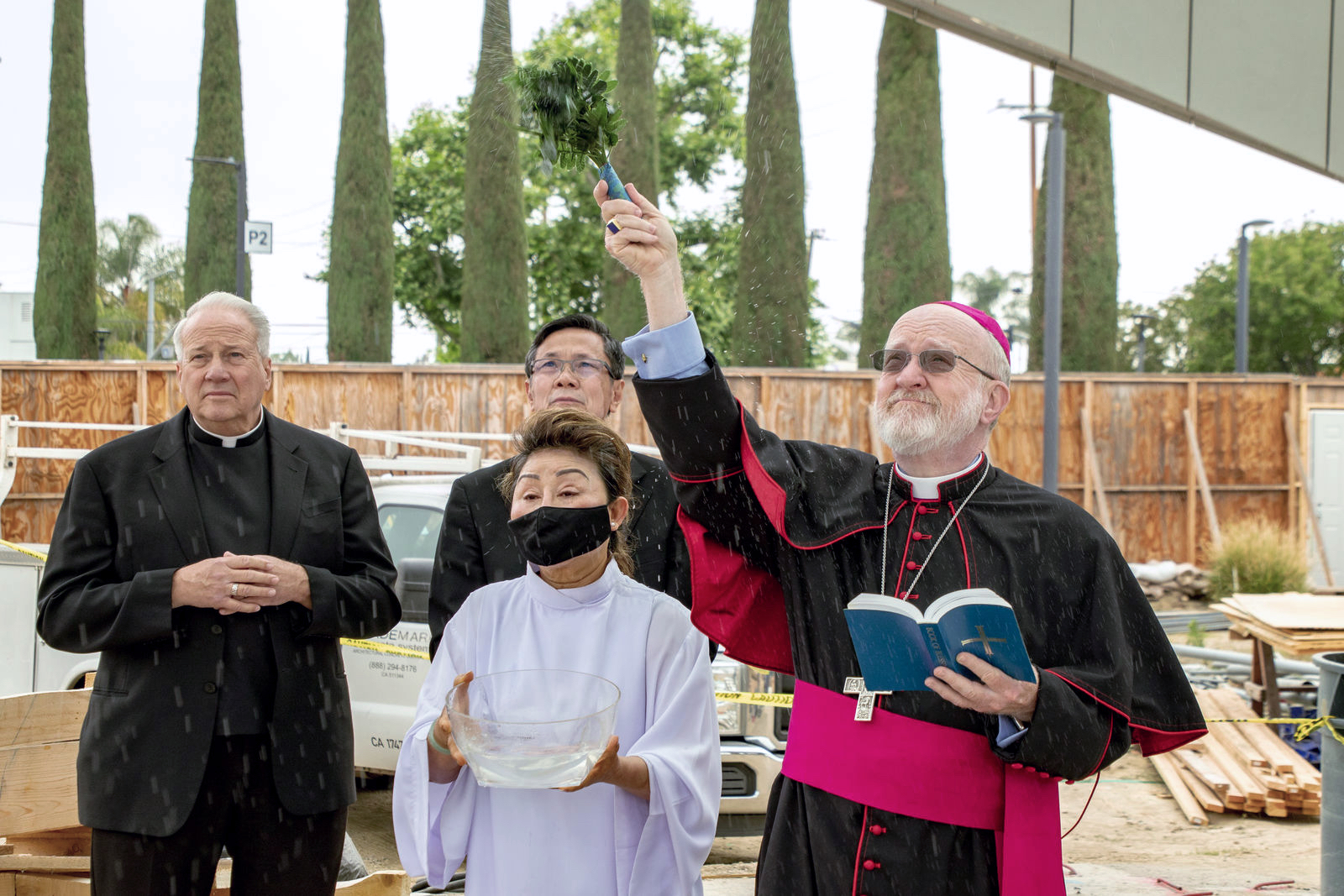 Bishop Kevin Vann blessing the Our Lady of La Vang sculpture during its installation. Photo courtesy Diocese of Orange. Note: Photo taken during construction.