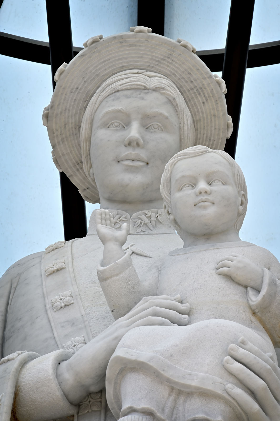 The Our Lady of La Vang statue at the Christ Cathedral campus depicts the Virgin Mary with a Eurasian face, holding the Baby Jesus and wearing a traditional Vietnamese áo dài dress and khăn đống hat. Photo courtesy Diocese of Orange.